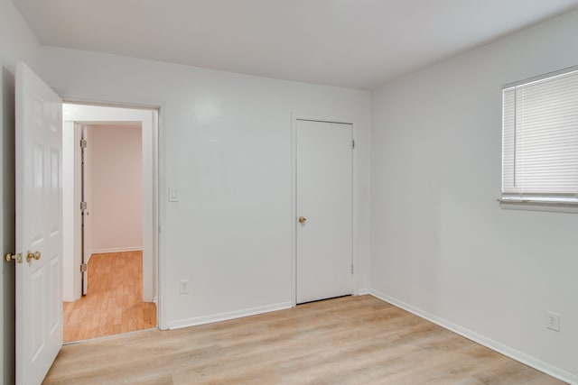 unfurnished bedroom with light wood-type flooring