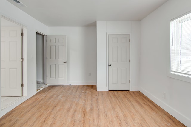 unfurnished bedroom featuring light wood-type flooring