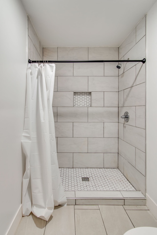 bathroom featuring curtained shower and toilet