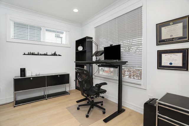 office area with ornamental molding and light wood-type flooring