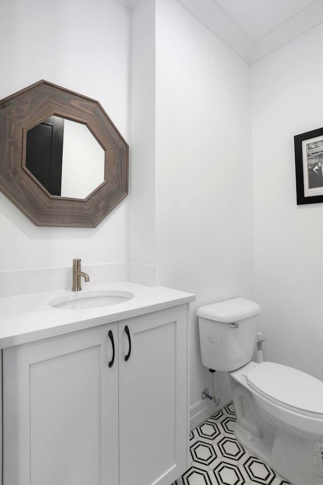 bathroom with tile patterned flooring, vanity, and toilet