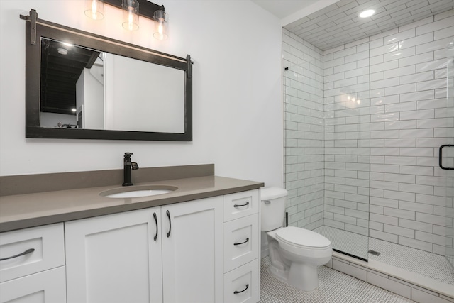 bathroom with vanity, toilet, tile patterned floors, and walk in shower