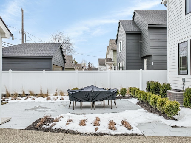 snowy yard featuring central AC unit