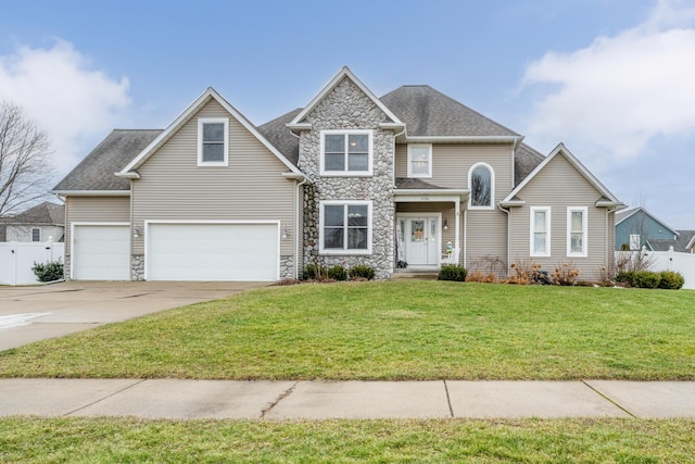 view of front of home with a garage and a front lawn