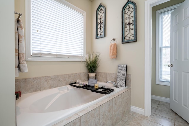 bathroom featuring a relaxing tiled tub, plenty of natural light, and tile patterned flooring