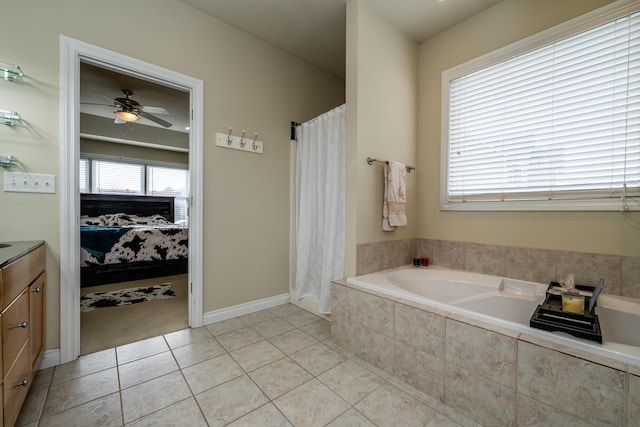 bathroom featuring vanity, tiled bath, tile patterned floors, and ceiling fan