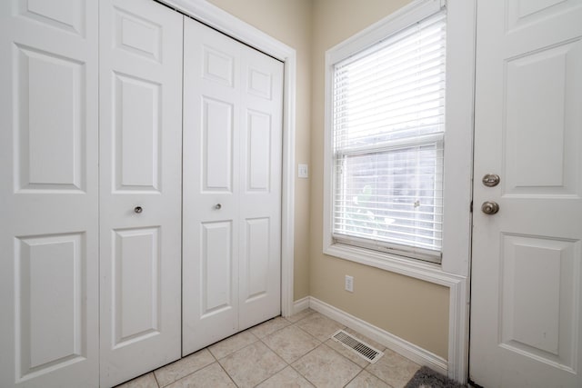 doorway featuring plenty of natural light and light tile patterned floors