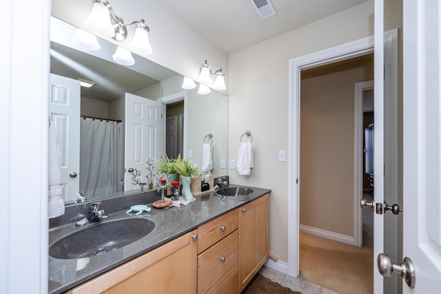 bathroom with tile patterned flooring and vanity