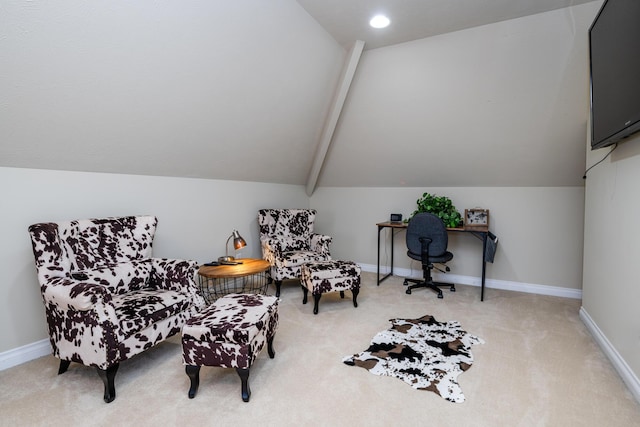 sitting room featuring lofted ceiling with beams and carpet