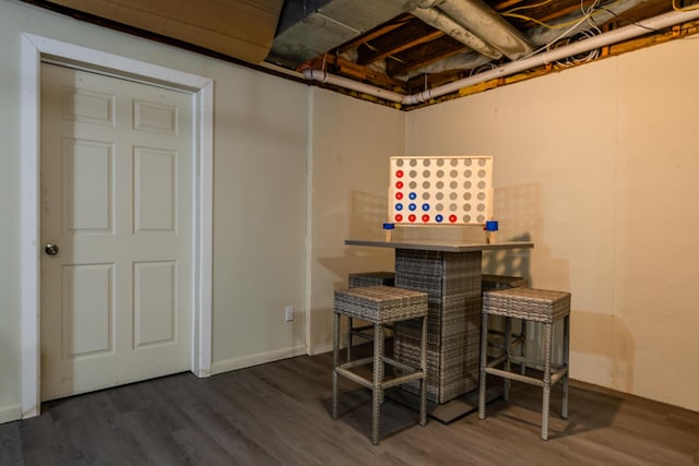 basement featuring dark hardwood / wood-style floors