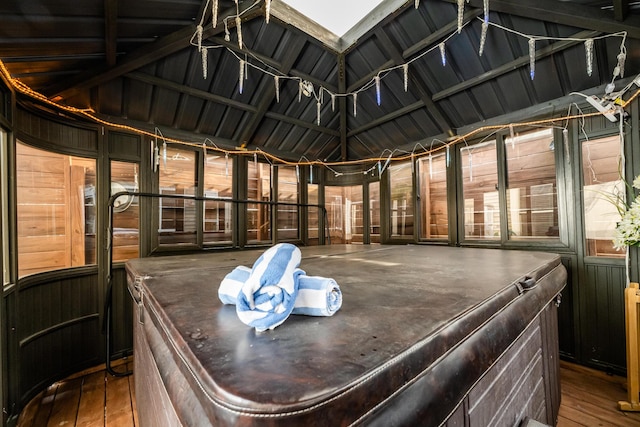 sunroom featuring lofted ceiling and a jacuzzi