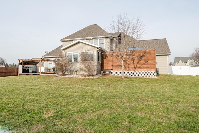 back of house featuring a lawn