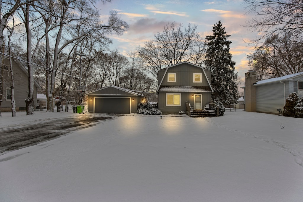 view of front of house featuring a garage and an outdoor structure