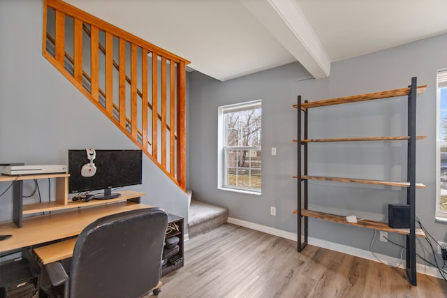 home office with beamed ceiling and light wood-type flooring