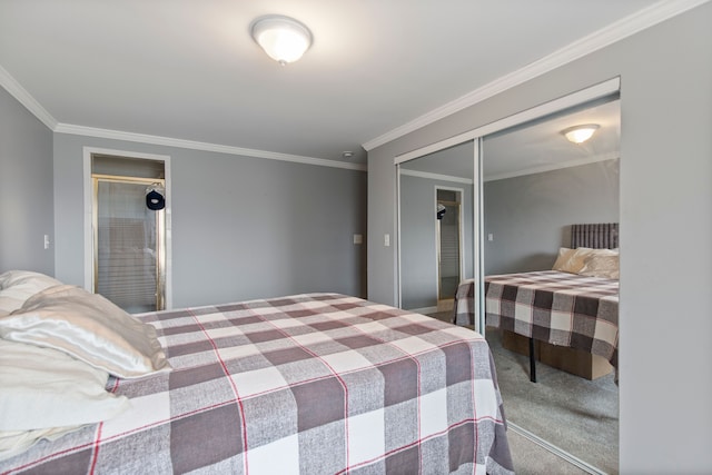 bedroom with ornamental molding, a closet, and carpet