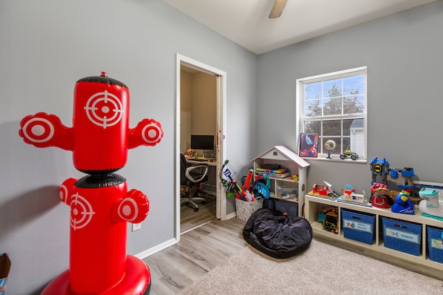 rec room featuring ceiling fan and light wood-type flooring