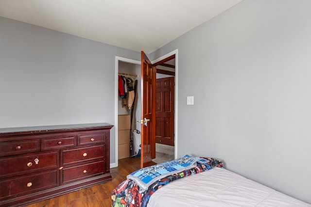 bedroom with dark hardwood / wood-style floors