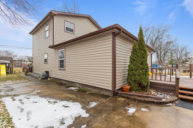 view of property exterior with a deck