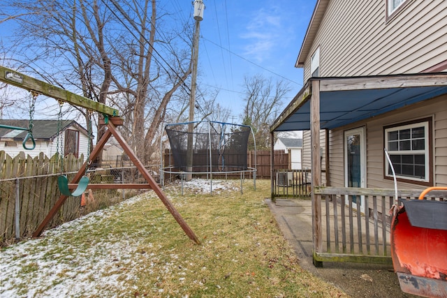 view of yard with a playground and a trampoline