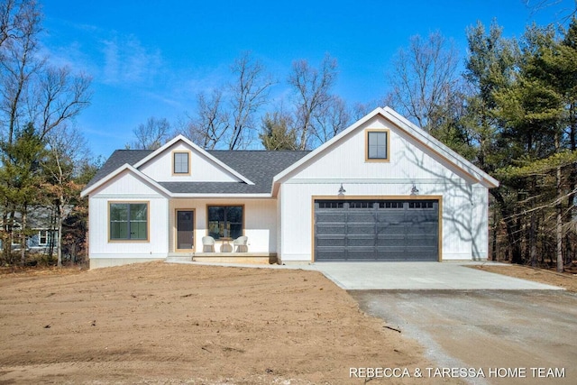 modern inspired farmhouse featuring a porch and a garage