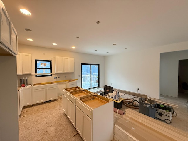 kitchen featuring recessed lighting, white cabinets, and a kitchen island