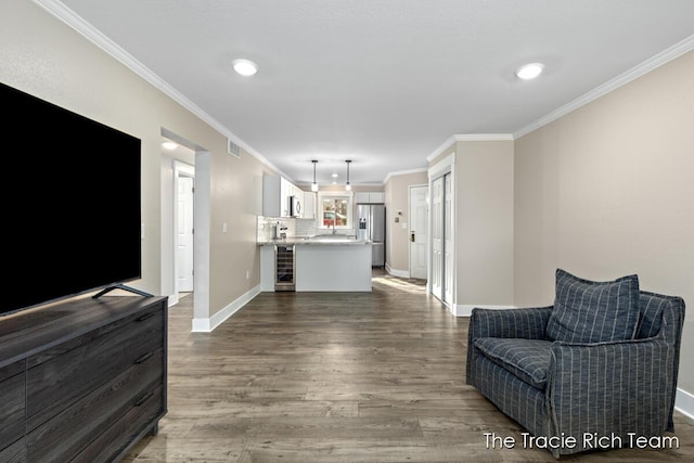 living room featuring wine cooler, dark wood-type flooring, and ornamental molding