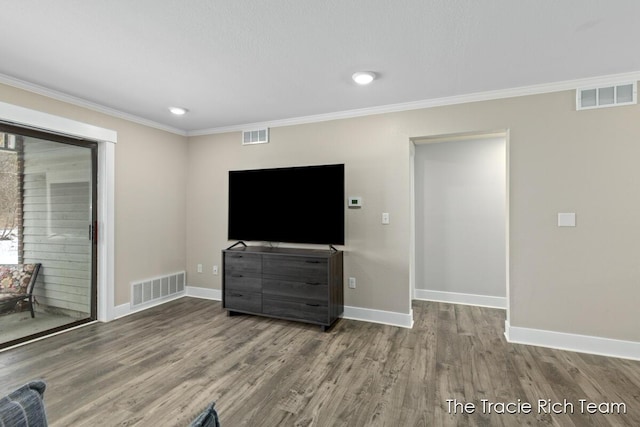 unfurnished living room featuring hardwood / wood-style flooring and ornamental molding