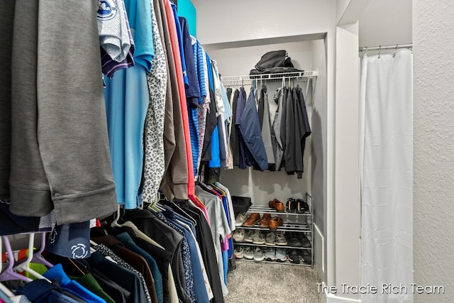 walk in closet featuring carpet flooring