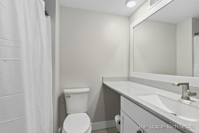 bathroom featuring vanity and toilet