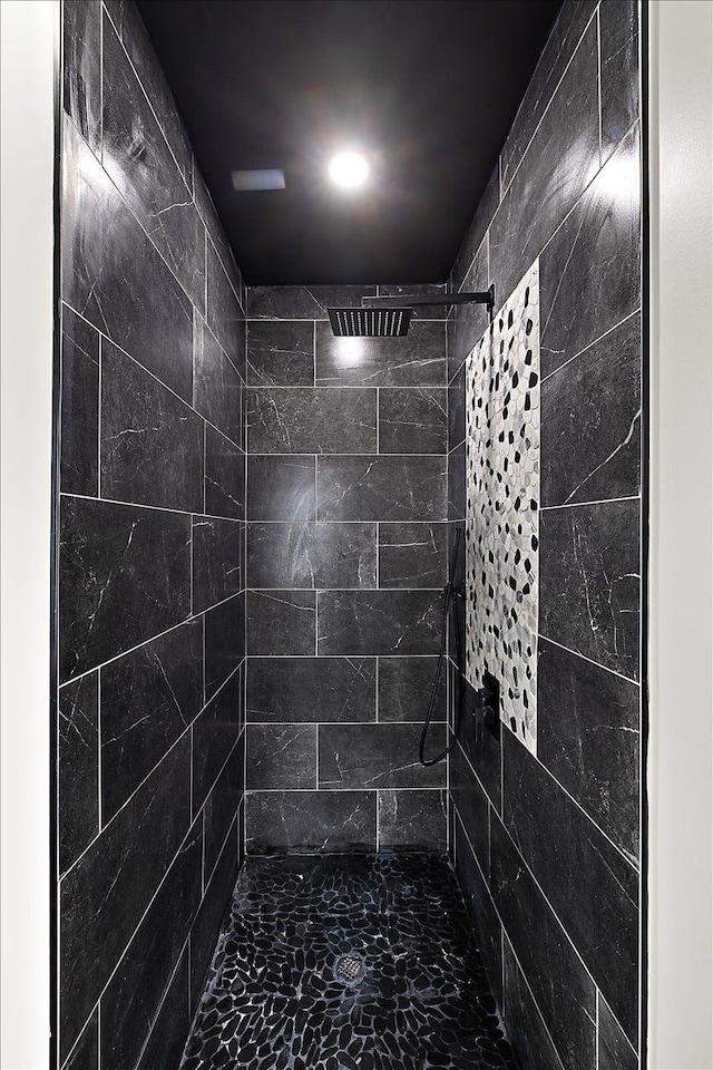 bathroom with a tile shower