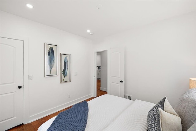 bedroom with dark wood-type flooring