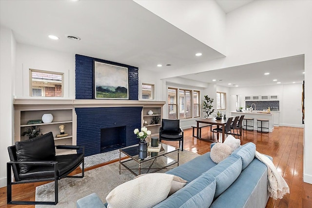 living room with a fireplace and light hardwood / wood-style flooring