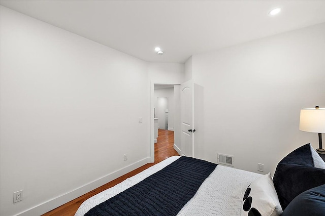 bedroom with wood-type flooring