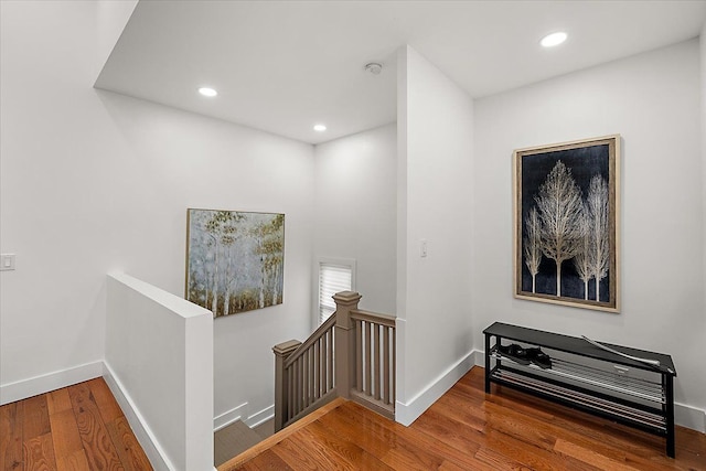 corridor with hardwood / wood-style floors