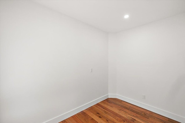 empty room with hardwood / wood-style flooring