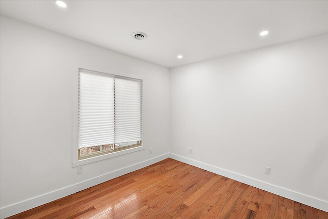 unfurnished room with hardwood / wood-style floors