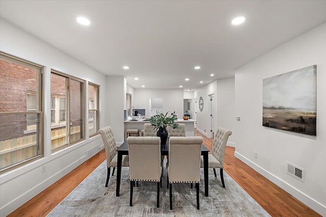 dining space with light hardwood / wood-style floors