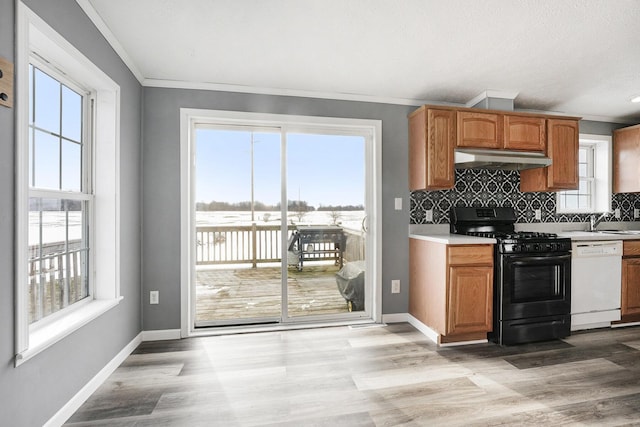 kitchen with tasteful backsplash, black range with gas cooktop, light hardwood / wood-style floors, and white dishwasher