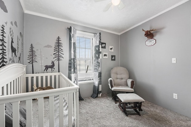 bedroom with carpet floors, a crib, ornamental molding, and a textured ceiling