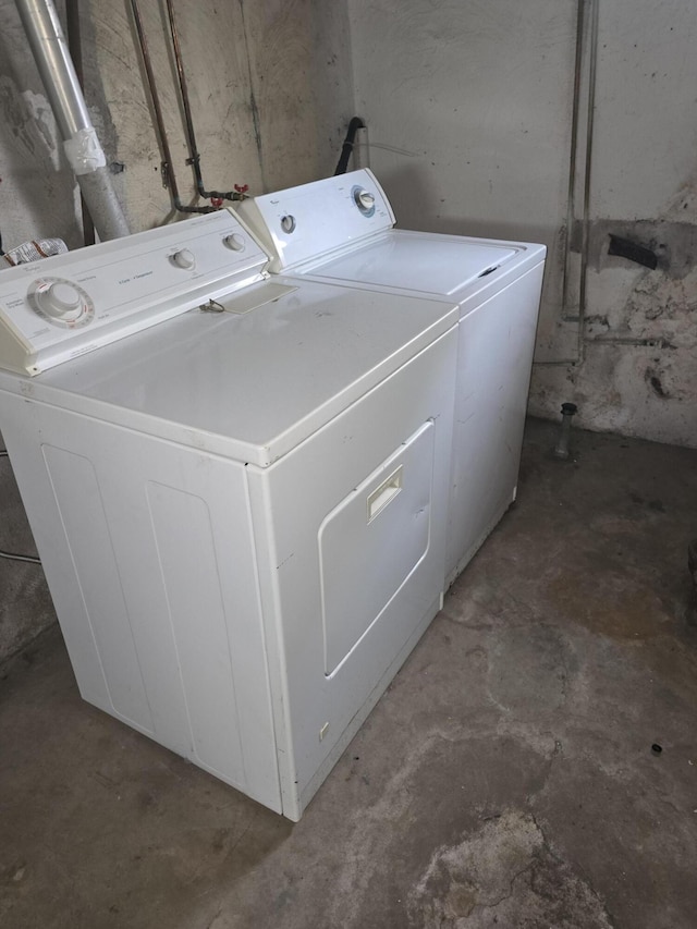 clothes washing area with washing machine and clothes dryer