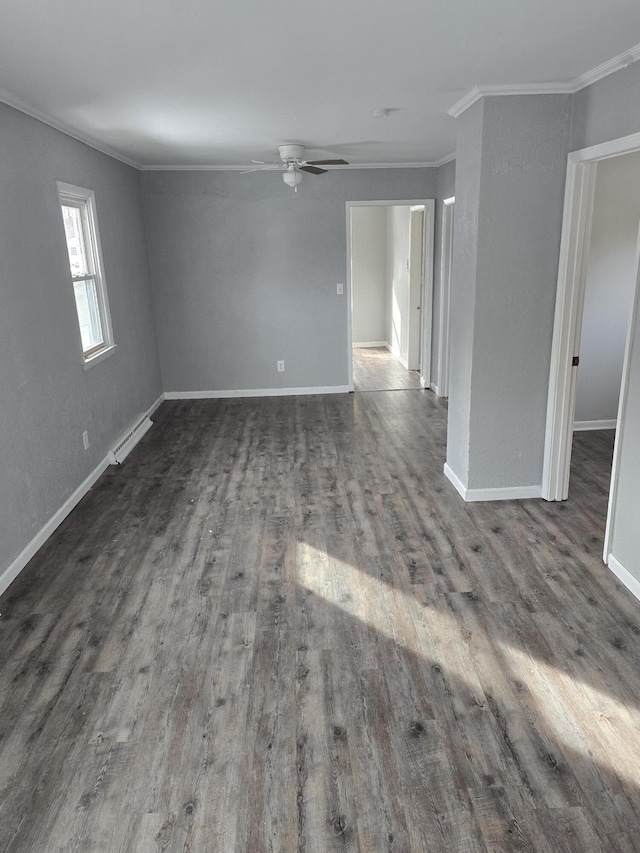 spare room featuring a baseboard heating unit, ornamental molding, dark hardwood / wood-style floors, and ceiling fan