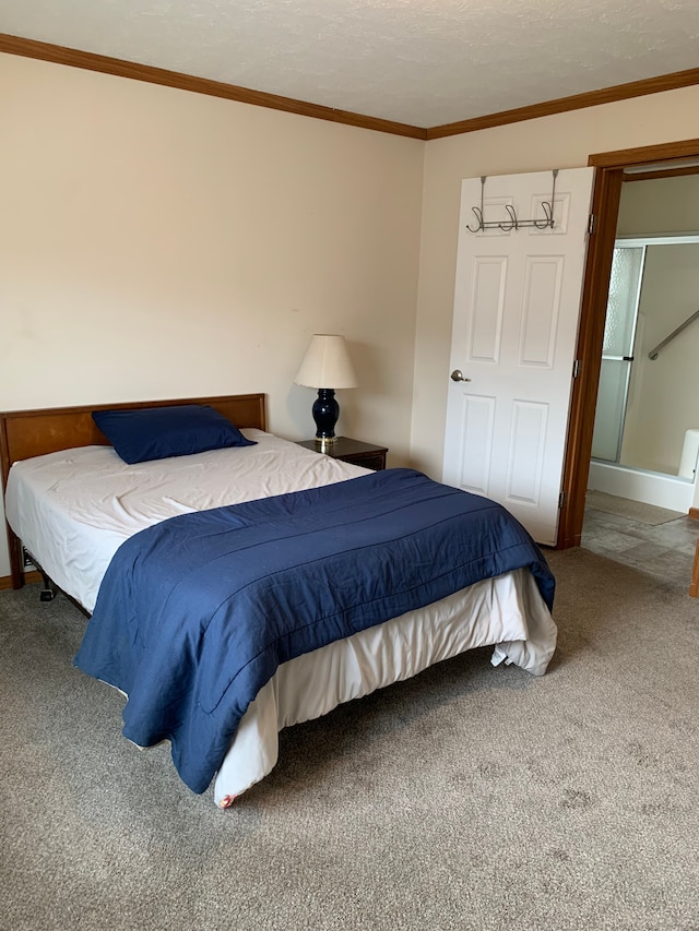 carpeted bedroom featuring ornamental molding and a textured ceiling