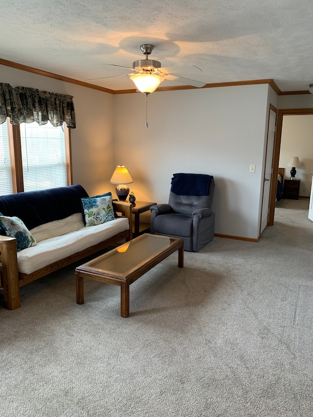 carpeted living room with crown molding, ceiling fan, and a textured ceiling