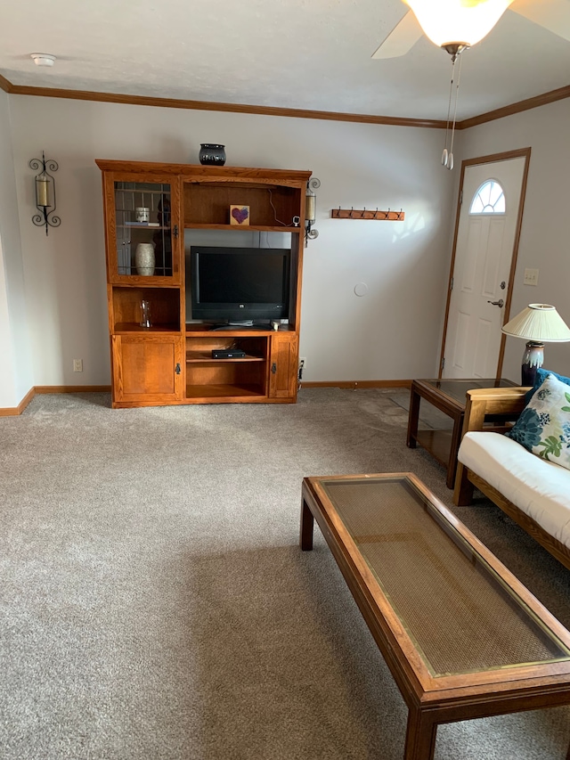 living room with crown molding, light colored carpet, and ceiling fan