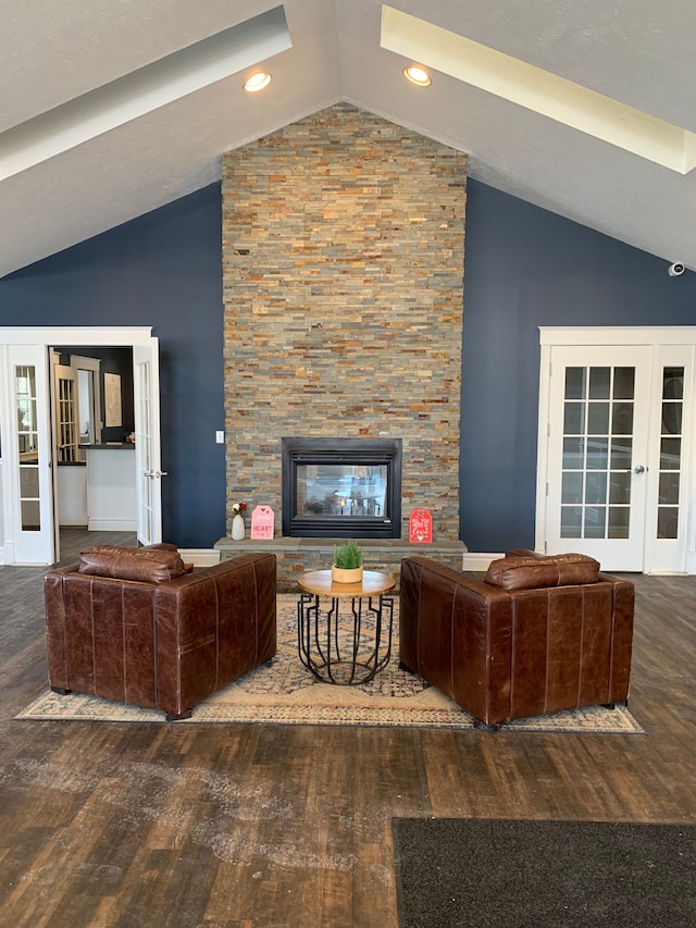 living room with dark hardwood / wood-style flooring, a fireplace, and french doors