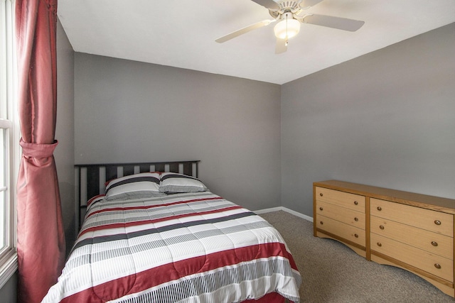 bedroom featuring ceiling fan and dark carpet