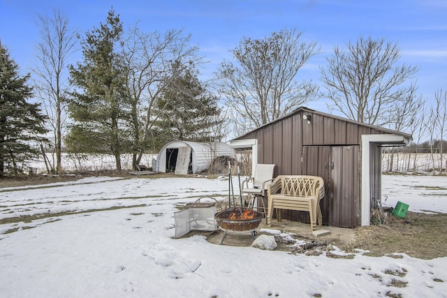 exterior space featuring a shed and a fire pit