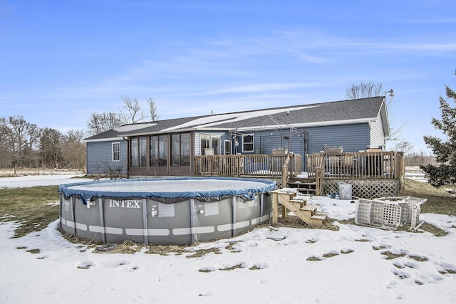 snow covered property with a swimming pool side deck