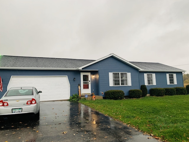 ranch-style house with a garage and a front lawn