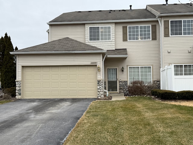 view of front of house featuring a garage and a front yard